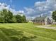 Picture of the home's exterior featuring a large yard at 405 E Cowing Dr, Muncie, IN 47303