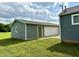 Detached garage featuring tidy siding and a large bay door at 405 E Cowing Dr, Muncie, IN 47303