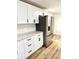 Bright kitchen featuring white cabinets, gray countertops, stainless steel appliances, and stylish black hardware at 405 E Cowing Dr, Muncie, IN 47303
