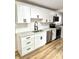 Modern kitchen with white cabinetry, stainless steel appliances, and stylish fixtures at 405 E Cowing Dr, Muncie, IN 47303