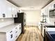 Renovated kitchen with white cabinetry, stainless steel appliances, and modern finishes with subway tile backsplash at 405 E Cowing Dr, Muncie, IN 47303