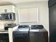 Updated laundry room with a window and new front load washer and dryer at 405 E Cowing Dr, Muncie, IN 47303