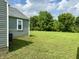Lush green backyard offering serene outdoor space and landscaping at 405 E Cowing Dr, Muncie, IN 47303