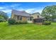 Expansive backyard features lush lawn, mature trees and brick home exterior with enclosed porch at 4070 Serenity Way Ct, Greenwood, IN 46142