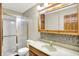 Bathroom features a shower with sliding doors and vanity with light wood cabinets at 4070 Serenity Way Ct, Greenwood, IN 46142