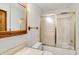 Bright bathroom featuring a tub-shower combination and a vanity with a wood-framed mirror at 4070 Serenity Way Ct, Greenwood, IN 46142