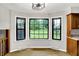 Bright breakfast nook featuring a bay window with black trim overlooking the landscaped yard and a modern light fixture at 4070 Serenity Way Ct, Greenwood, IN 46142