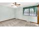 Bright bedroom with plush carpeting, ceiling fan, and window with curtains at 4070 Serenity Way Ct, Greenwood, IN 46142