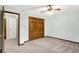 Neutral bedroom with a ceiling fan, closet with wood doors, and plush carpeting at 4070 Serenity Way Ct, Greenwood, IN 46142