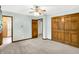 Bright bedroom with plush carpeting, ceiling fan, and wood closet doors at 4070 Serenity Way Ct, Greenwood, IN 46142