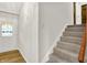 Entryway features wood-look flooring, front door with stained glass window, and carpeted staircase at 4070 Serenity Way Ct, Greenwood, IN 46142