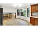 Open kitchen area featuring hardwood floors, natural cabinets, and a bay window at 4070 Serenity Way Ct, Greenwood, IN 46142