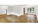 Updated living space features wood-look floors, a large window, and access to other rooms at 4070 Serenity Way Ct, Greenwood, IN 46142