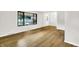 Bright, open living room features new floors, a large window and fresh neutral paint at 4070 Serenity Way Ct, Greenwood, IN 46142