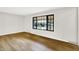 Clean and bright living room boasts wood-look floors and large windows for natural light at 4070 Serenity Way Ct, Greenwood, IN 46142