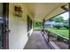 Inviting covered porch with decorative railing offers a view of the landscaped yard and neighborhood at 4070 Serenity Way Ct, Greenwood, IN 46142