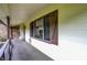 Covered porch featuring neutral carpet, decorative railings and attractive windows with dark shutters at 4070 Serenity Way Ct, Greenwood, IN 46142