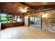 Relaxing enclosed porch with tile floors, ceiling fan, and brick accent wall at 4070 Serenity Way Ct, Greenwood, IN 46142