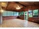 Bright sunroom featuring neutral tile flooring, wood paneled walls and ceiling, and many windows at 4070 Serenity Way Ct, Greenwood, IN 46142
