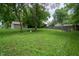 Lush green backyard featuring a hammock, detached garage, and privacy fencing at 4903 E Naomi St, Indianapolis, IN 46203