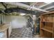 Spacious basement area with utility connections, storage shelving, and a neutral carpet at 4903 E Naomi St, Indianapolis, IN 46203