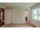 Bedroom with open doorways and a large window providing ample natural light at 4903 E Naomi St, Indianapolis, IN 46203