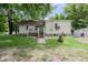 Charming single-Gathering home with a quaint front porch and walkway surrounded by mature trees at 4903 E Naomi St, Indianapolis, IN 46203