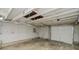 Spacious garage interior features pegboard walls, concrete floor, and a white garage door with natural lighting at 4903 E Naomi St, Indianapolis, IN 46203