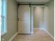 Hallway view featuring a sliding barn door adding rustic charm and visual interest to the space at 4903 E Naomi St, Indianapolis, IN 46203