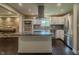 Bright, modern kitchen featuring stainless steel appliances, a spacious island, and stylish granite countertops at 4903 E Naomi St, Indianapolis, IN 46203