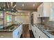 Well-lit kitchen with stainless appliances, cooktop island, granite counters, and open floor plan at 4903 E Naomi St, Indianapolis, IN 46203