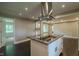 Open concept kitchen with granite island, stainless vent hood, hardwood floors, and modern recessed lighting at 4903 E Naomi St, Indianapolis, IN 46203