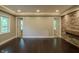 Open living space with recessed lights, hardwood floors, and stone feature wall at 4903 E Naomi St, Indianapolis, IN 46203