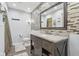 Bathroom featuring a stone patterned backsplash, dark wood vanity, and a framed mirror at 5152 Coppertree Ln, Avon, IN 46123