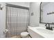 Bathroom featuring a gray patterned shower curtain and a white vanity with a decorative mirror at 5152 Coppertree Ln, Avon, IN 46123