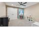 Inviting bedroom with a ceiling fan, wood accent wall, and natural light creating a comfortable and stylish living space at 5152 Coppertree Ln, Avon, IN 46123