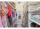 Walk-in closet with shelving, rods and a mirror at the end at 5152 Coppertree Ln, Avon, IN 46123
