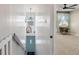Bright hallway featuring a unique blue door and a glimpse into a bedroom with stylish decor, enhancing the home's charm at 5152 Coppertree Ln, Avon, IN 46123