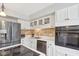 Well-lit kitchen showcasing white cabinets, stainless steel appliances, and a backsplash, blending style with modern functionality at 5152 Coppertree Ln, Avon, IN 46123