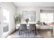 Dining room features a modern table, an abstract painting, and a large window for natural light at 519 Sutherland Ave, Indianapolis, IN 46205