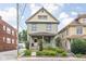 Charming two-story home boasts manicured landscaping and inviting front porch at 519 Sutherland Ave, Indianapolis, IN 46205