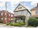 Charming two-story home featuring a covered front porch with landscaped front yard and welcoming curb appeal at 519 Sutherland Ave, Indianapolis, IN 46205
