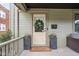 Charming front door with wreath, welcome mat, and potted flower decoration at 519 Sutherland Ave, Indianapolis, IN 46205