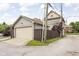 View of the detached garage with neutral colored siding and a dark wood privacy fence at 519 Sutherland Ave, Indianapolis, IN 46205