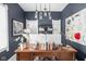 Chic home office featuring a large desk, modern lighting, and contemporary artwork at 519 Sutherland Ave, Indianapolis, IN 46205