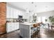 Modern kitchen with white cabinets, granite countertops, and stainless steel appliances at 519 Sutherland Ave, Indianapolis, IN 46205