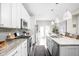 Stylish kitchen boasts stainless appliances, granite countertops, and a view to the backyard patio at 519 Sutherland Ave, Indianapolis, IN 46205