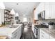Updated kitchen with stainless appliances, granite countertops, and an open view to the living area at 519 Sutherland Ave, Indianapolis, IN 46205