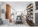 Open-concept living space featuring a brick wall, shelves, and view of the kitchen at 519 Sutherland Ave, Indianapolis, IN 46205