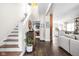 Open-concept living space with hardwood floors and staircase with wooden treads at 519 Sutherland Ave, Indianapolis, IN 46205